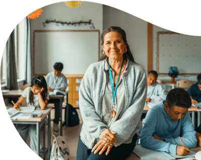 Female teacher in a classroom with children Female teacher in a classroom with children
